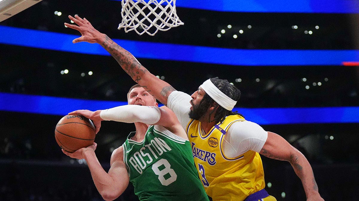 Boston Celtics Center Kristaps Porzingis (8) shoots the ball against Los Angeles Lakers forward Anthony Davis (3) in the first half at Cripto.com Arena. 