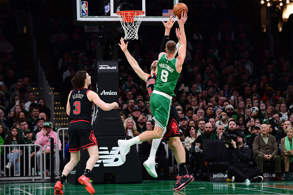 Boston Celtics center Kristaps Porzingis (8) shoots the ball over Chicago Bulls center Nikola Vucevic (9) during the second half at TD Garden.