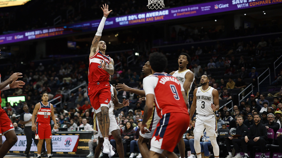 Washington Wizards forward Kyle Kuzma (33) shoots the ball as New Orleans Pelicans guard Trey Murphy III (25) looks on in the second quarter at Capital One Arena.