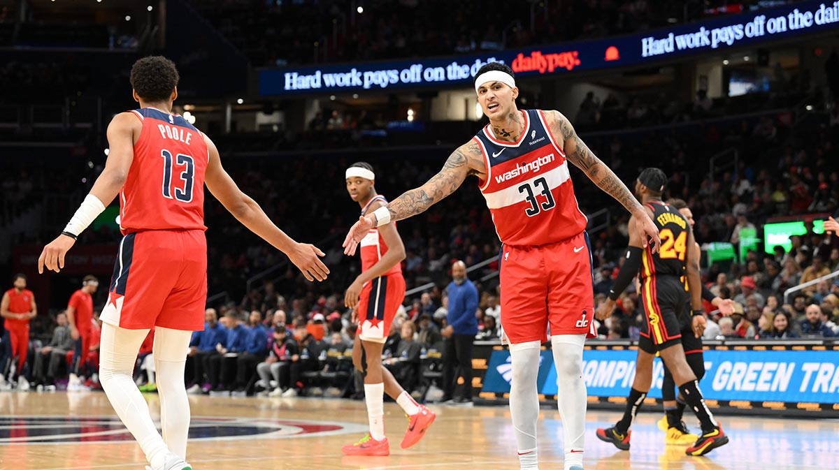 Washington Vizards The front Kyle Kuza (33) is celebrated with the guard Jordan Poole (13) during the first half against the Atlant Hawks in the capital of those arena. 