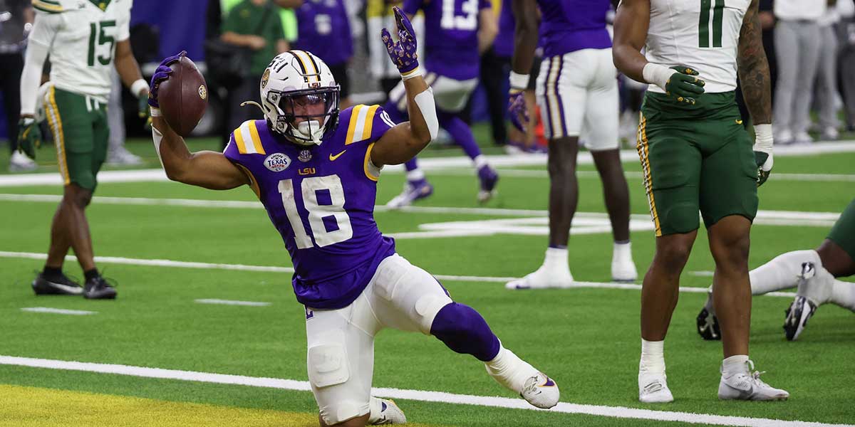 Dec 31, 2024; Houston, TX, USA; LSU Tigers running back Josh Williams (18) celebrates a touchdown against the Baylor Bears in the second half at NRG Stadium. Mandatory Credit: Thomas Shea-Imagn Images