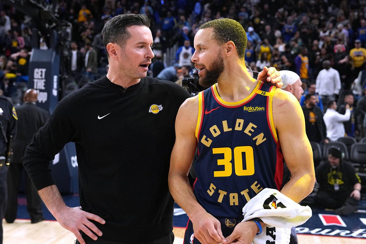 Los Angeles Lakers head coach JJ Redick (left) and Golden State Warriors guard Stephen Curry (30) talk after the game at Chase Center.