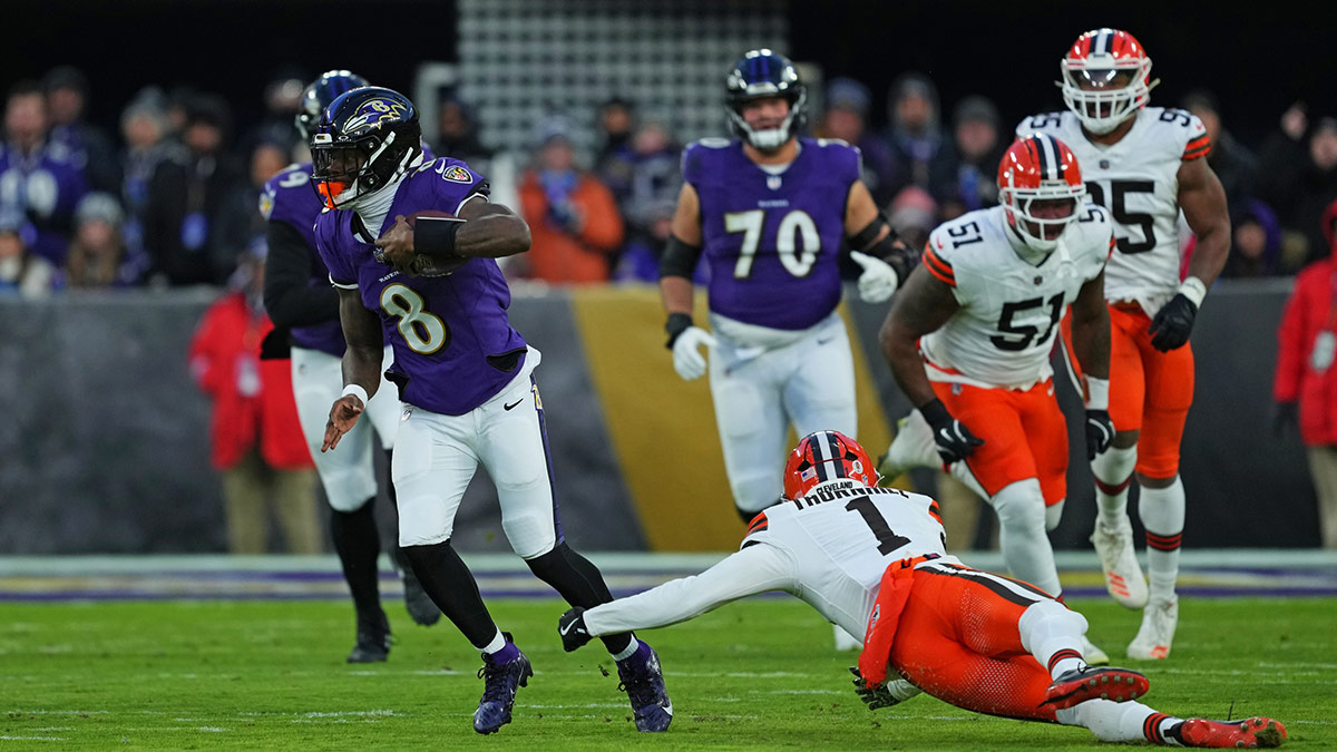 Baltimore Ravens quarterback Lamar Jackson (8) runs the ball during the first quarter against Cleveland Browns safety Juan Thornhill (1) at M&T Bank Stadium.