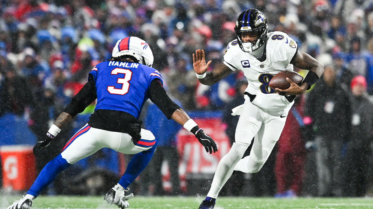 Jan 19, 2025; Orchard Park, New York, USA; Baltimore Ravens quarterback Lamar Jackson (8) runs the ball against Buffalo Bills safety Damar Hamlin (3) during the fourth quarter in a 2025 AFC divisional round game at Highmark Stadium. 