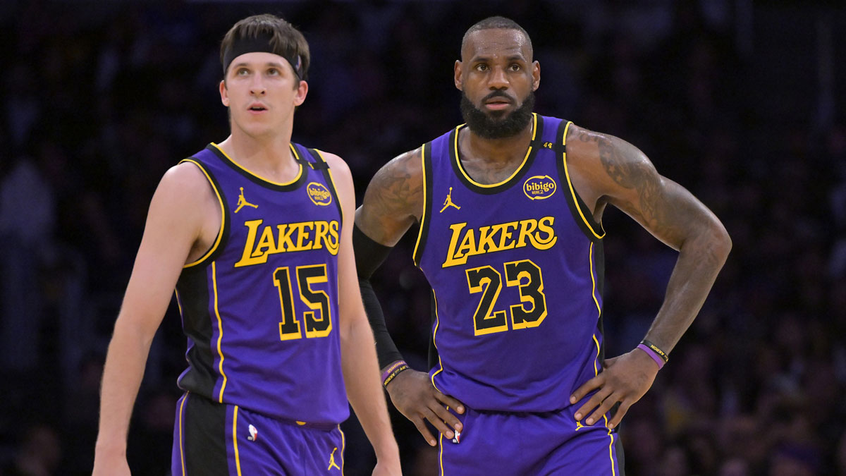 Los Angeles Lakers guard Austin Reaves (15) and forward LeBron James (23) talk on the court against the Brooklyn Nets at Crypto.com Arena.