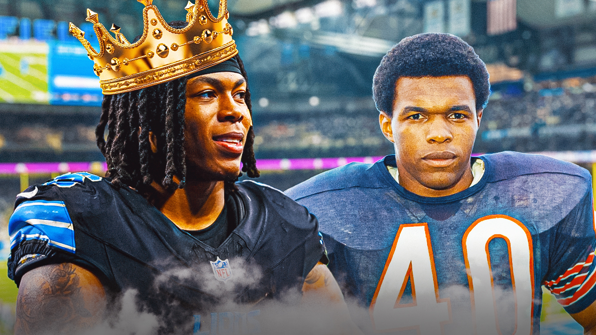 Lions RB Jahmyr Gibbs smiling and wearing a crown while standing next to former Bears RB Gale Sayers. Background is Ford Field.