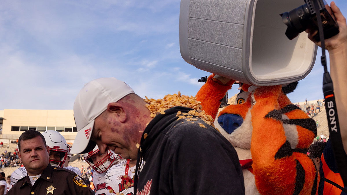 Tony the Tiger tosses corn flakes on Jeff Brohm, head Louisville football coach, after their win against Washington in the 91st Tony the Tiger Sun Bowl game on Tuesday, Dec. 31, 2024 at the Sun Bowl Stadium in El Paso, Texas.