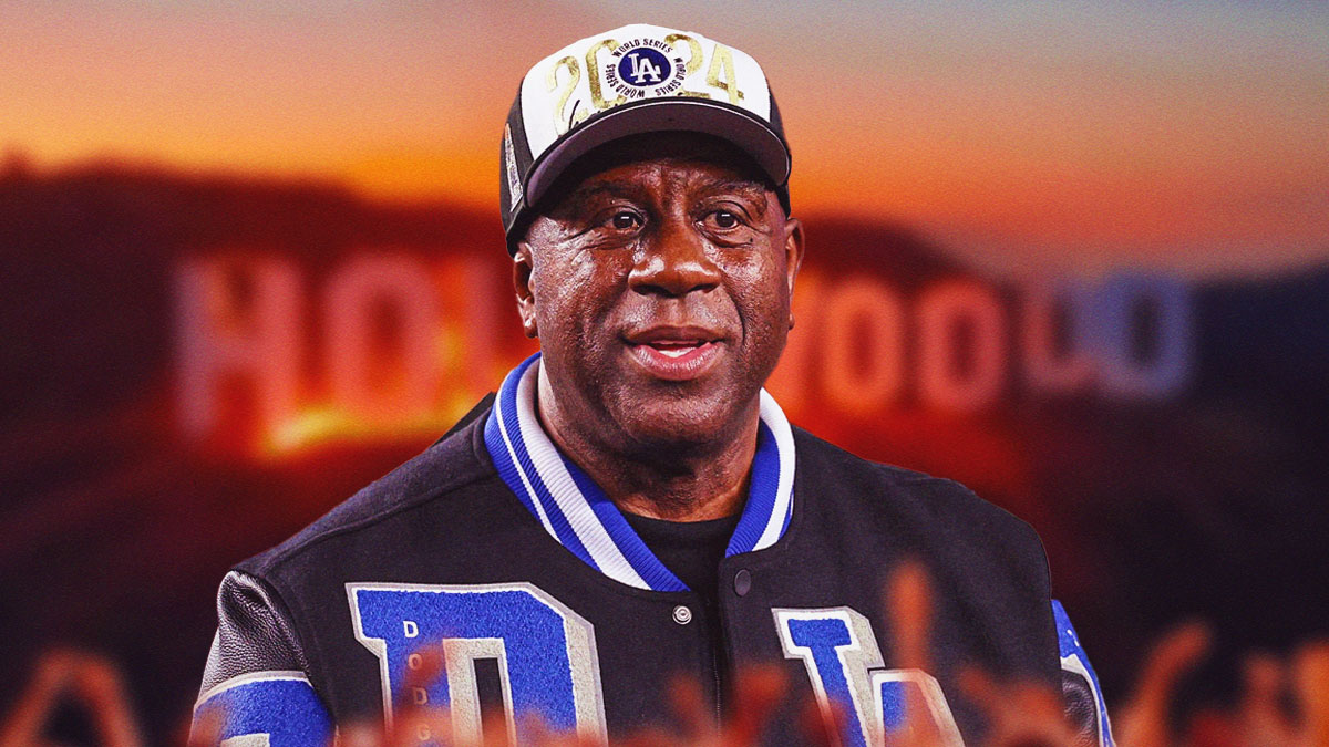 Dodgers owner Magic Johnson in front of Hollywood sign