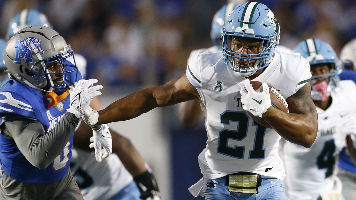 Tulane Green Wave running back Makhi Hughes (21) runs with the ball during the first half against the Memphis Tigers at Simmons Bank Liberty Stadium.