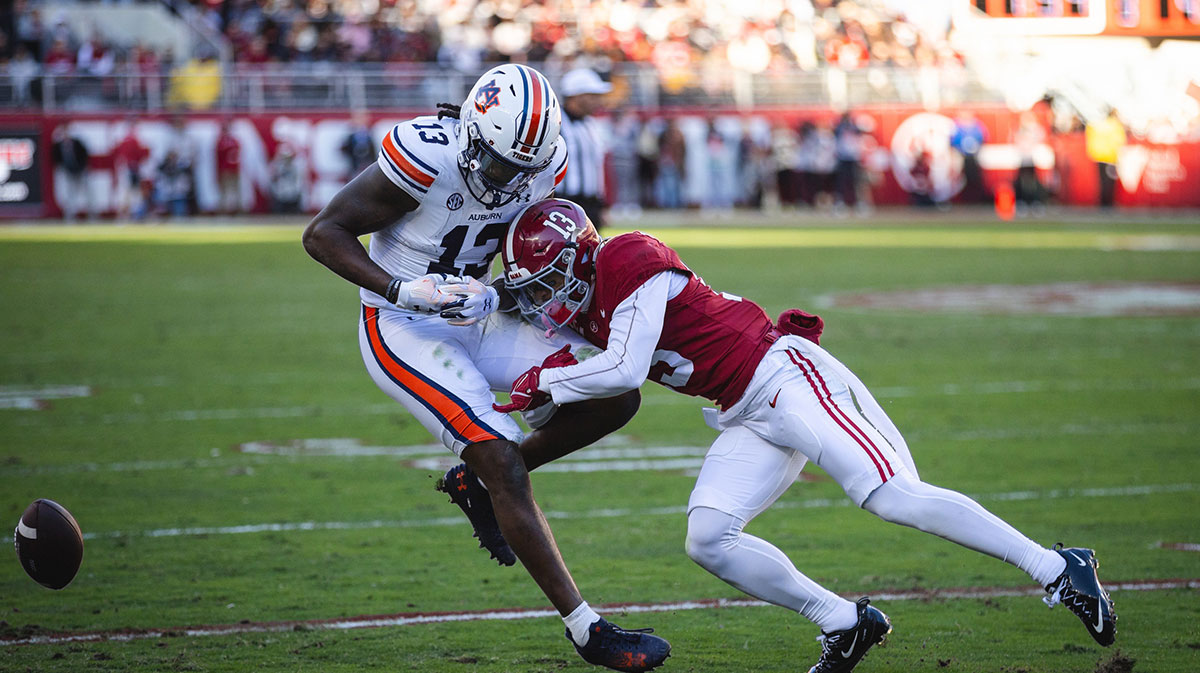 Nov 30, 2024; Tuscaloosa, Alabama, USA; Alabama Crimson Tide defensive back Malachi Moore (13) tackles Auburn Tigers tight end Rivaldo Fairweather (13) during the first quarter at Bryant-Denny Stadium.