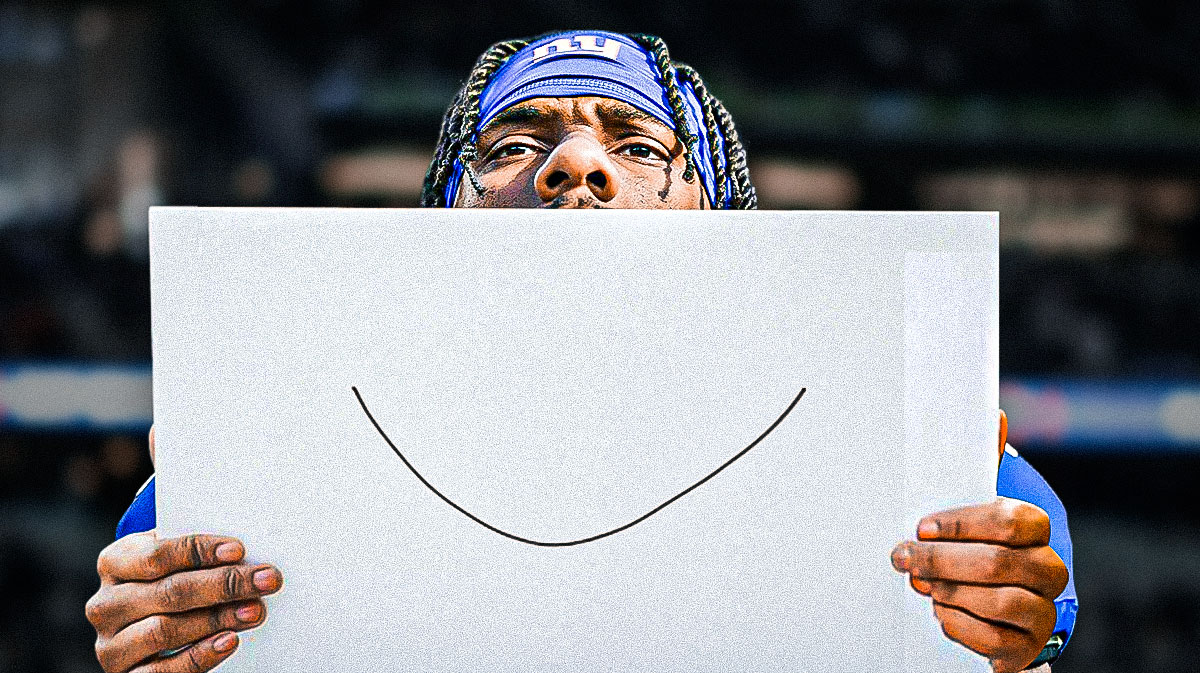 Malik Nabers (Giants) holding a paper with a drawing of smile in front of his face