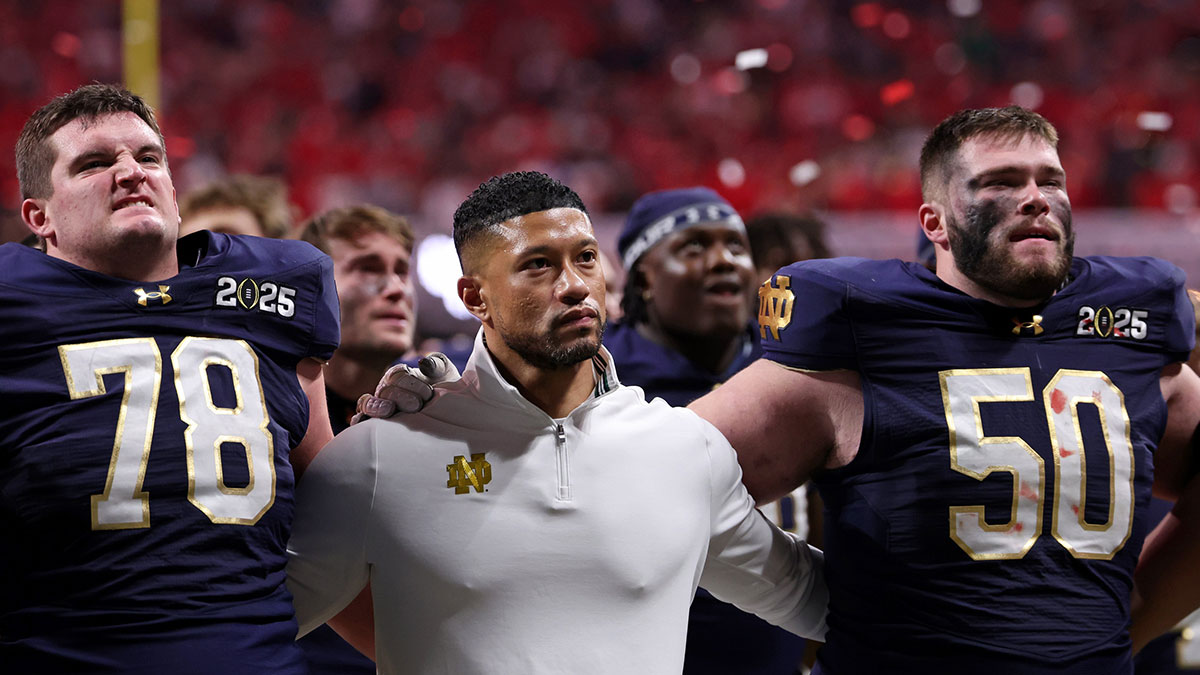 Notre Dame Fighting Irish offensive lineman Pat Coogan (78), head coach Marcus Freeman, and offensive lineman Rocco Spindler (50) react after losing against the Ohio State Buckeyes in the CFP National Championship college football game at Mercedes-Benz Stadium.