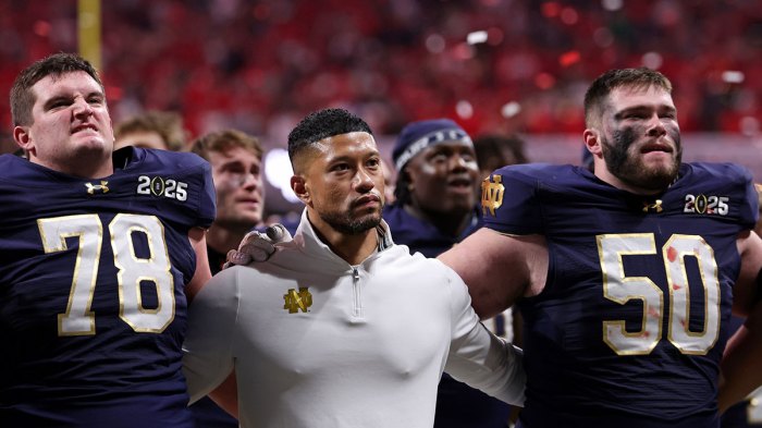 Notre Dame Fighting Irish offensive lineman Pat Coogan (78), head coach Marcus Freeman, and offensive lineman Rocco Spindler (50) react after losing against the Ohio State Buckeyes in the CFP National Championship college football game at Mercedes-Benz Stadium.