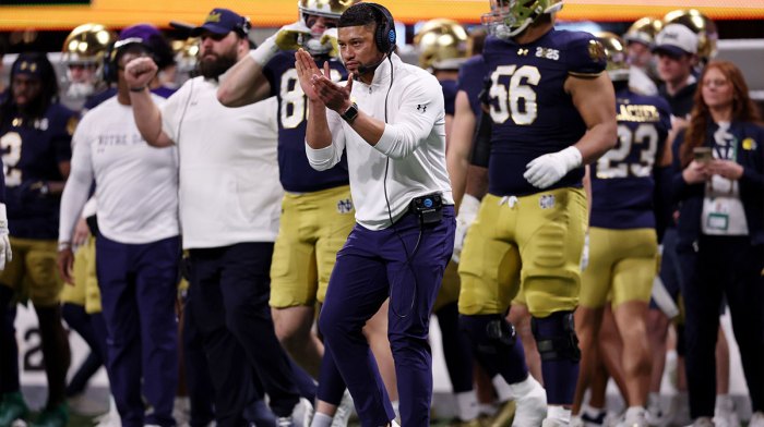 Notre Dame Fighting Irish head coach Marcus Freeman reacts after a play against the Ohio State Buckeyes during the second half the CFP National Championship college football game at Mercedes-Benz Stadium.
