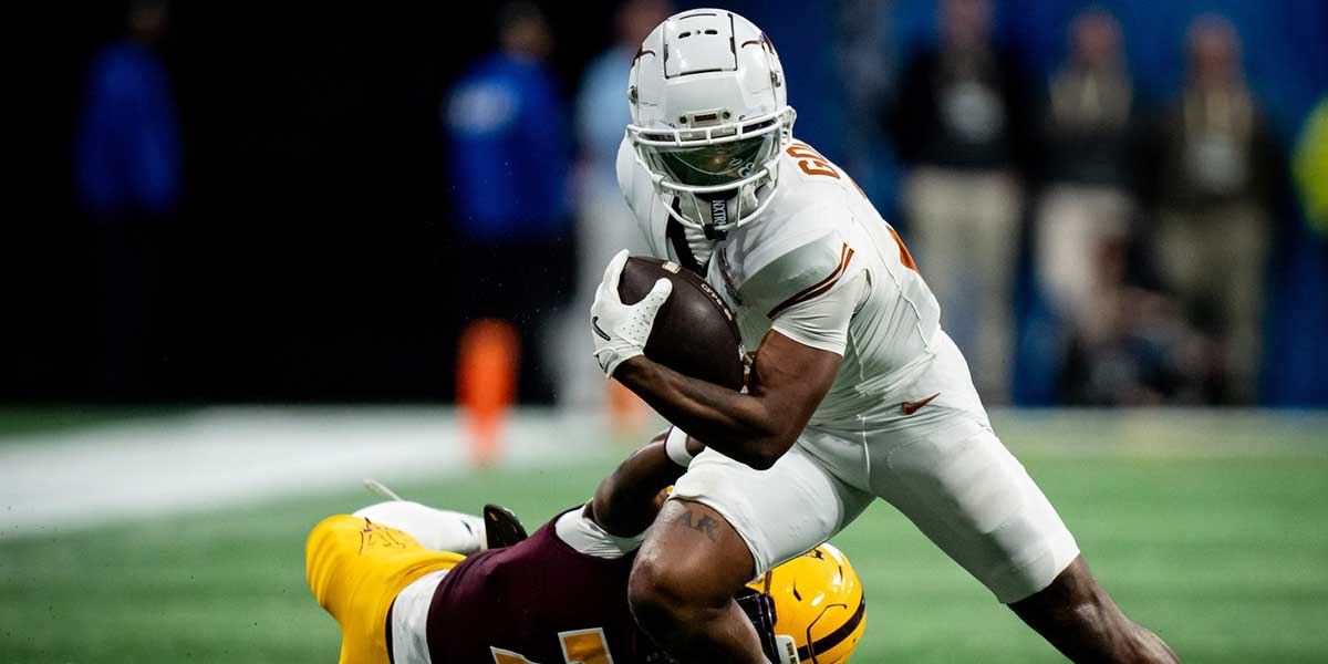 Texas Longhorns wide receiver Matthew Golden (2) evades a tackle from Arizona State Sun Devils defensive back Shamari Simmons (7) in the fourth quarter as the Texas Longhorns play the Arizona State Sun Devils in the Peach Bowl College Football Playoff quarterfinal at Mercedes-Benz Stadium in Atlanta, Georgia, Jan. 1, 2025.