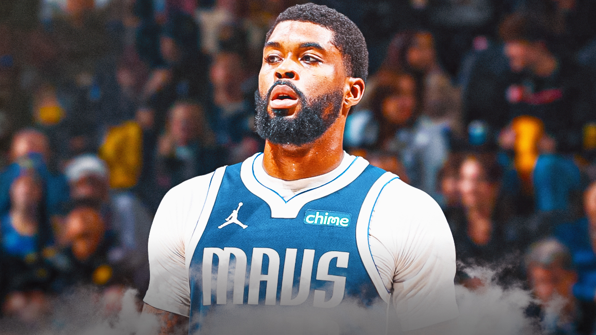 Mavericks Naji Marshall looking serious and sitting down on an NBA sideline.