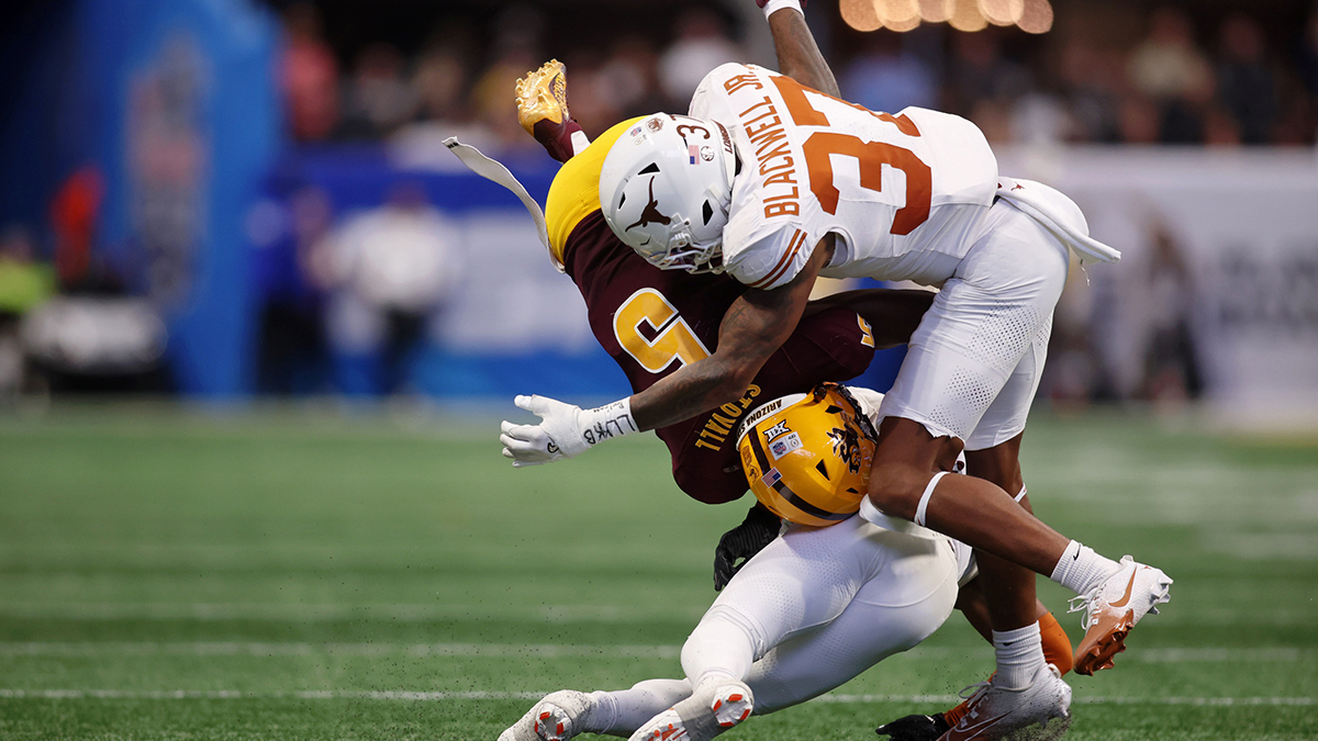 Arizona State football Sun Devils wide receiver Melquan Stovall (5) is tackled by Texas Longhorns defensive back Jahdae Barron (bottom) and linebacker Morice Blackwell Jr. (37) during the first half of the Peach Bowl at Mercedes-Benz Stadium