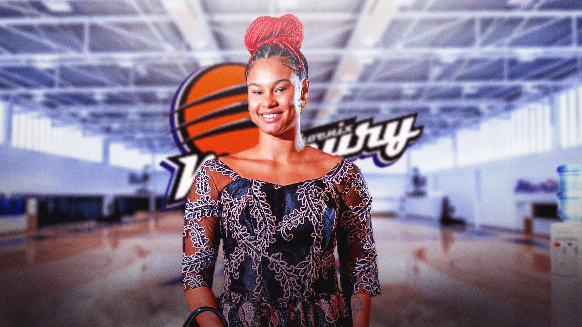 Satou Sabally in street clothes looking at the Phoenix Mercury practice facility with the Mercury logo in the background.