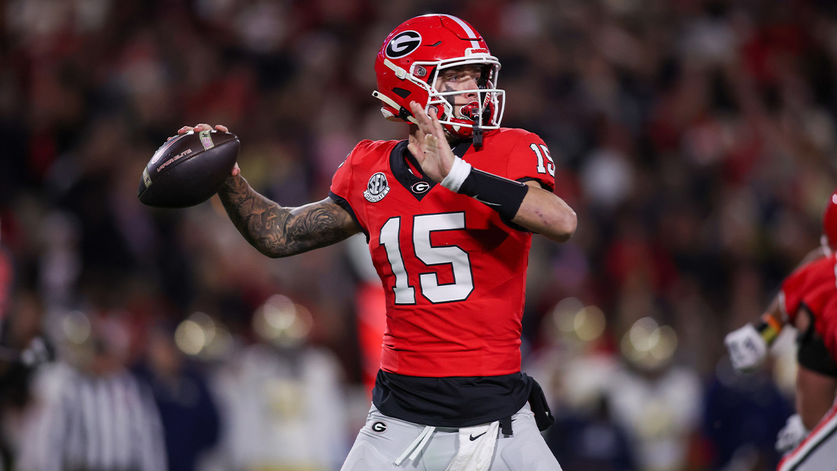 Georgia Bulldogs quarterback Carson Beck (15) throws a pass against the Georgia Tech Yellow Jackets in the first quarter at Sanford Stadium.