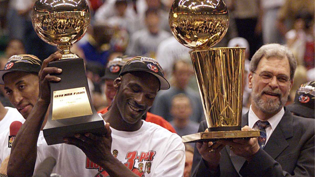 Chicago Bull Guard Michael Jordan Holds MVP Trophy and Trainer Phil Jackson, holding the championship trophy after the bulls beat Utah Jazz to win their name at 6. NBA. 