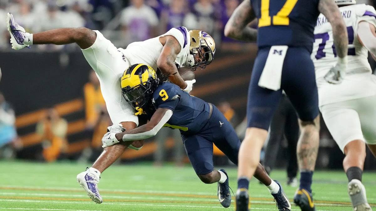 Washington wide receiver Ja'Lynn Polk is tackled by Michigan defensive back Rod Moore during the second half of the College Football Playoff national championship game against Washington at NRG Stadium