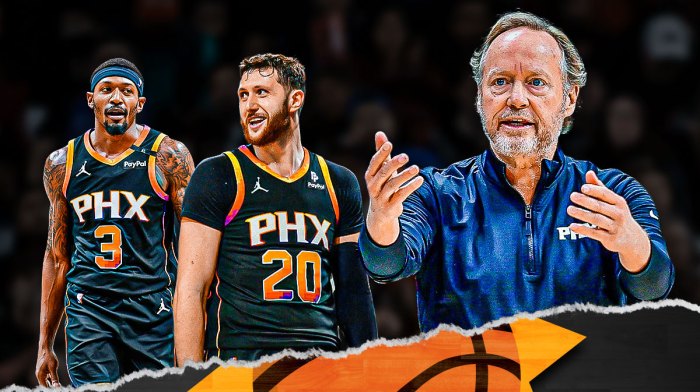 Suns head coach Mike Budenholzer talking, with Bradley Beal and Jusuf Nurkic next to him, and an NBA bench in the background