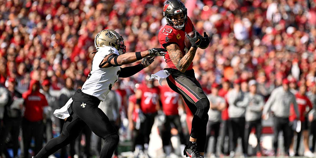 Tampa Bay Buccaneers wide receiver Mike Evans (13) catches the ball as New Orleans Saints defensive back Jordan Howden (31) looks to make the tackle in the first half at Raymond James Stadium.