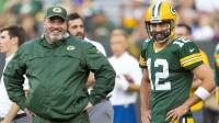 Green Bay Packers head coach Mike McCarthy talks with quarterback Aaron Rodgers (12) during warmups prior to the game against the Philadelphia Eagles at Lambeau Field.