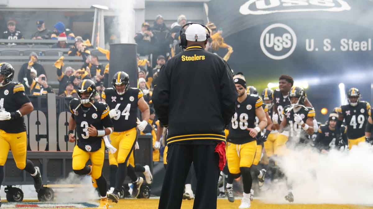 December 25, 2024; Pittsburgh, PA, USA; The Pittsburgh Steelers take the field as head coach Mike Tomlin (center) looks on before the game against the Kansas City Chiefs at Akrisur Stadium. 