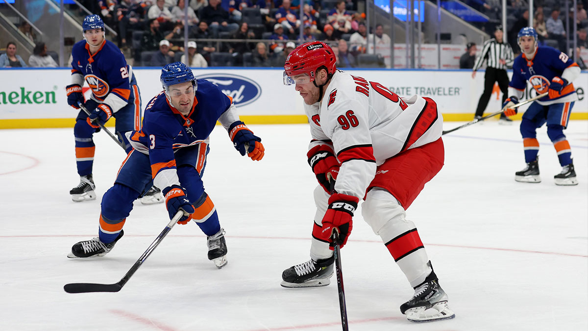 Carolina Hurricanes right wing Mikko Rantanen (96) skates with the puck against New York Islanders defenseman Adam Pelech (3) during the second period at UBS Arena.