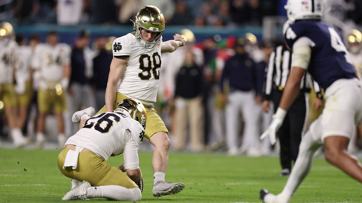 Notre Dame Fighting Irish place kicker Mitch Jeter (98) kicks the ball in the second half against the Penn State Nittany Lions in the Orange Bowl at Hard Rock Stadium.