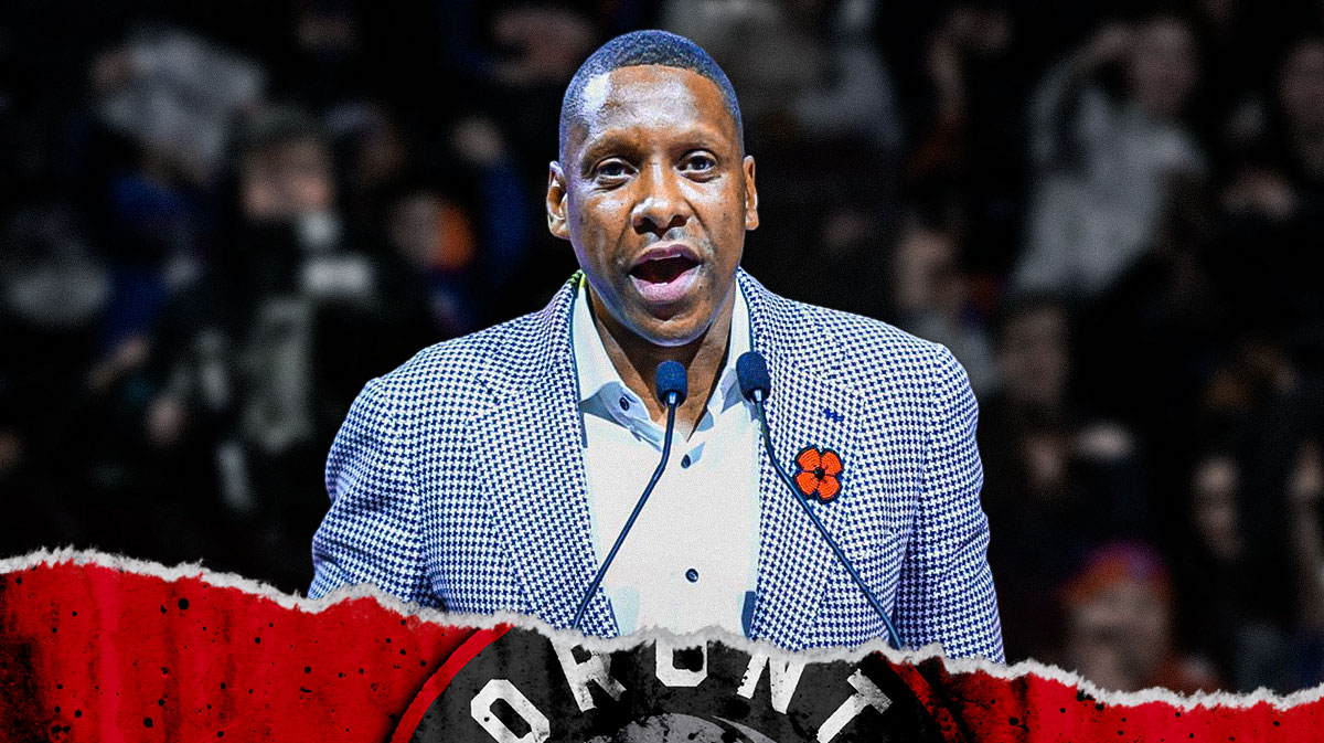 Photo: Masai Ujiri, Raptors logo beside him