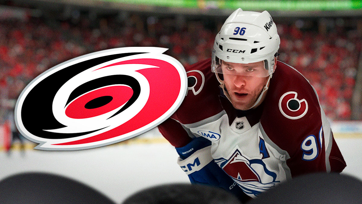 Mikko Rantanen looking stern, Carolina Hurricanes logo, hockey rink in background
