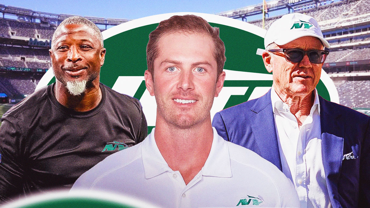 Jets owner Woody Johnson and head coach Aaron Glenn with new GM Darren Mougey in between them - with a New York Jets logo behind them.