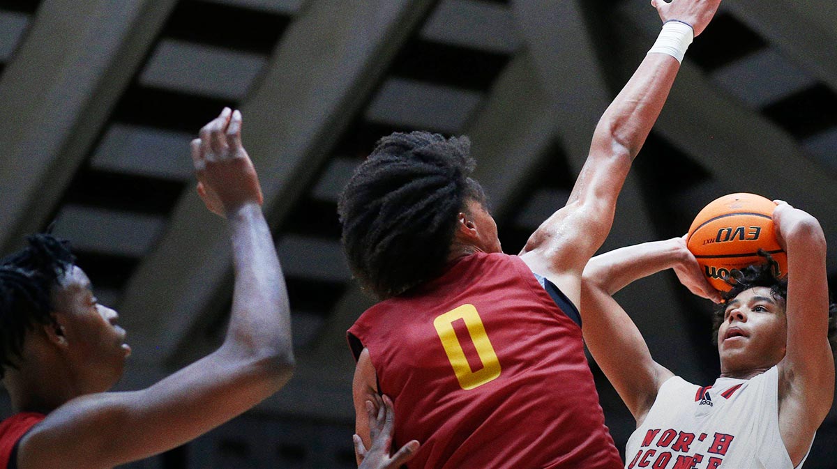 North Oconee's Justin Wise (2) takes a shot while being defended by Holy Innocents Episcopal's Will Hopkins (0) and Holy Innocents Episcopal's Caleb Wilson (24) during the GHSA high school basketball AAAA Region 8 championship game in Macon, Ga., on Wednesday, March 6, 2024. North Oconee won 65-60.