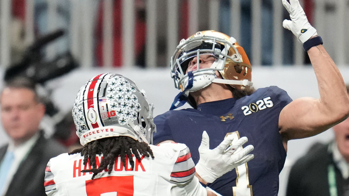 Notre Dame Fighting Irish wide receiver Jaden Greathouse (1) reaches for a pass against Ohio State Buckeyes cornerback Jordan Hancock (7) in the second half of the CFP National Championship football game at Mercedes-Benz Stadium.