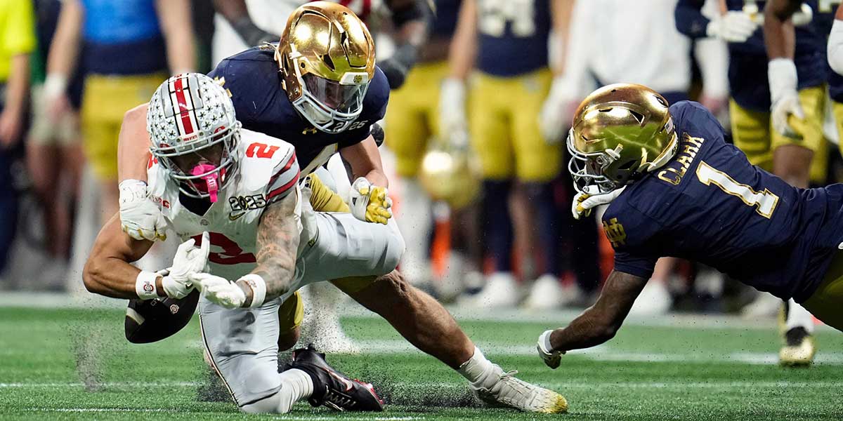 Notre Dame Fighting Irish linebacker Drayk Bowen (34) knocks the ball away from Ohio State Buckeyes wide receiver Emeka Egbuka (2) for a fumble in the fourth quarter during the College Football Playoff National Championship at Mercedes-Benz Stadium in Atlanta on January 20, 2025.