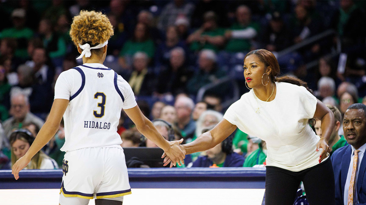 Notre Dame head coach Niele Ivey, right, slaps hands with guard Hannah Hidalgo (3) during a NCAA women's basketball game between No. 3 Notre Dame and Wake Forest.