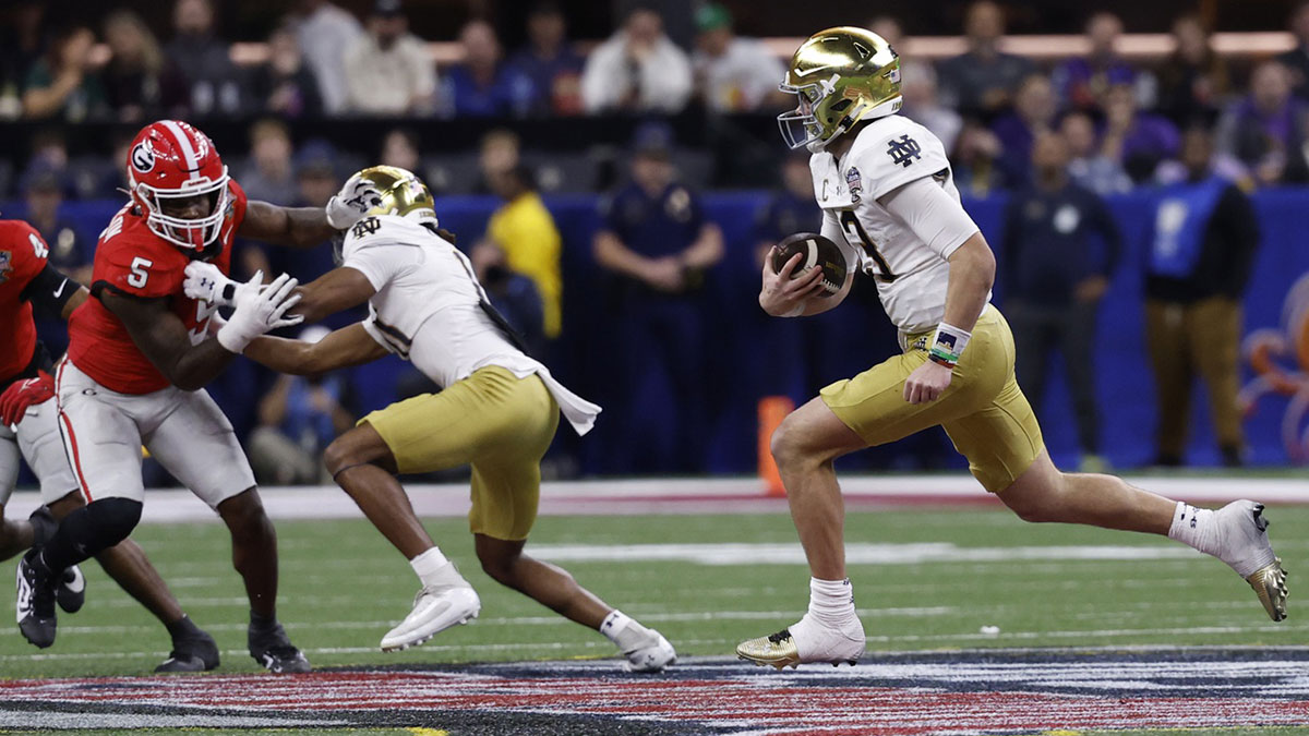Notre Dame Fighting Irish quarterback Riley Leonard (13) runs with the ball as Georgia Bulldogs linebacker Raylen Wilson (5) chases during the third quarter at Caesars Superdome.
