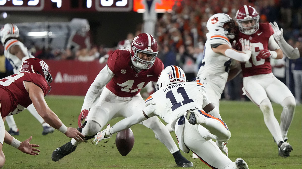 Auburn Tigers wide receiver Malcolm Simmons (11) fumbles a punt but recovers as Alabama Crimson Tide defensive back Prince Butler (48) and linebacker Justin Okoronkwo (41) close in during second half at Bryant-Denny Stadium. Alabama won 28-14.