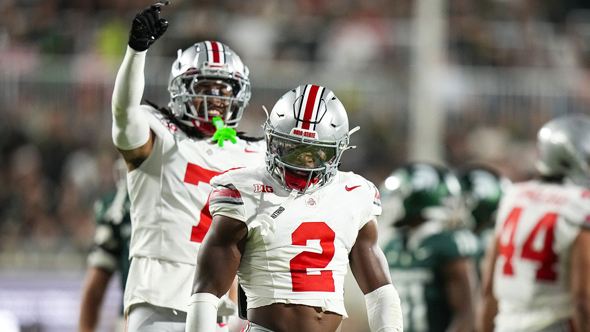 Ohio State Buckeyes safety Caleb Downs (2) celebrates after tackling Michigan State Spartans running back Nate Carter (5) in the first half on Saturday at Spartan Stadium.