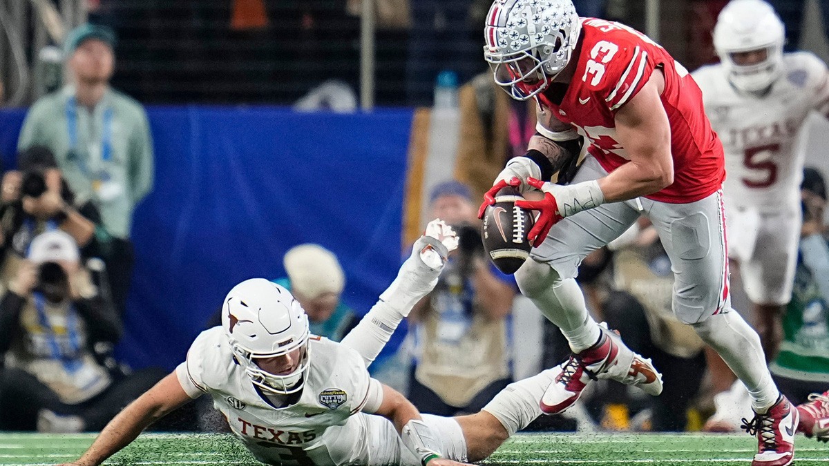 Ohio State Backeys defensive end Jack Sawyer (33) sacks Texas Longhorns quarterback Quinn Evers (3) forcing a fumble during the second half of the Cotton Bowl Classic College Football Playoff semifinal game at AT&T Stadium in Arlington, Texas, on January 10, 2025. Sawyer returned the fumble for a touchdown, and Ohio State won 28-14.