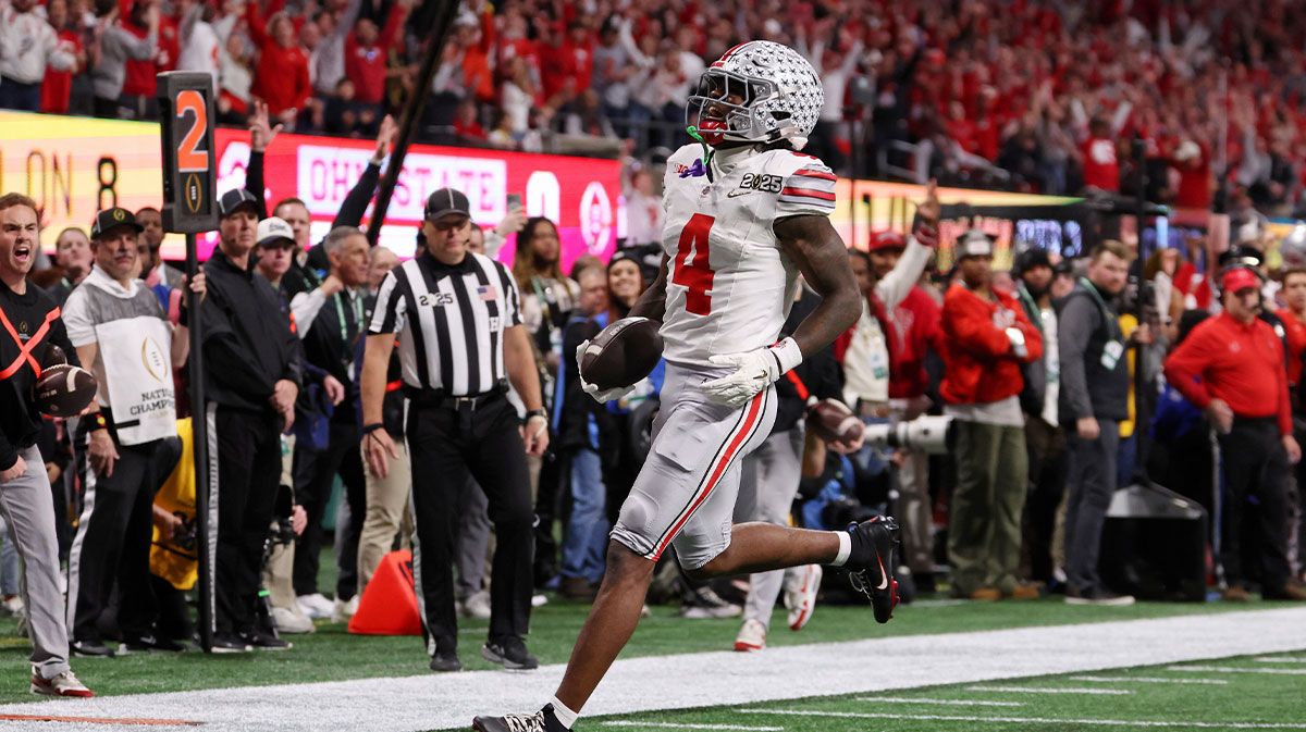 Ohio State Buckeyes wide receiver Jeremiah Smith (4) runs with the ball for a touchdown during the first half the CFP National Championship college football game at Mercedes-Benz Stadium.