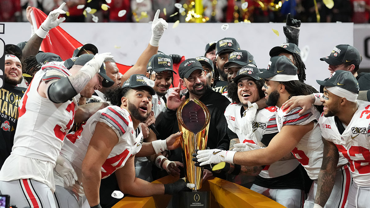 Ohio State Buckeyes head coach Ryan Day and his team celebrate with the CFP National Championship trophy after defeating the Notre Dame Fighting Irish in the CFP National Championship college football game at Mercedes-Benz Stadium.