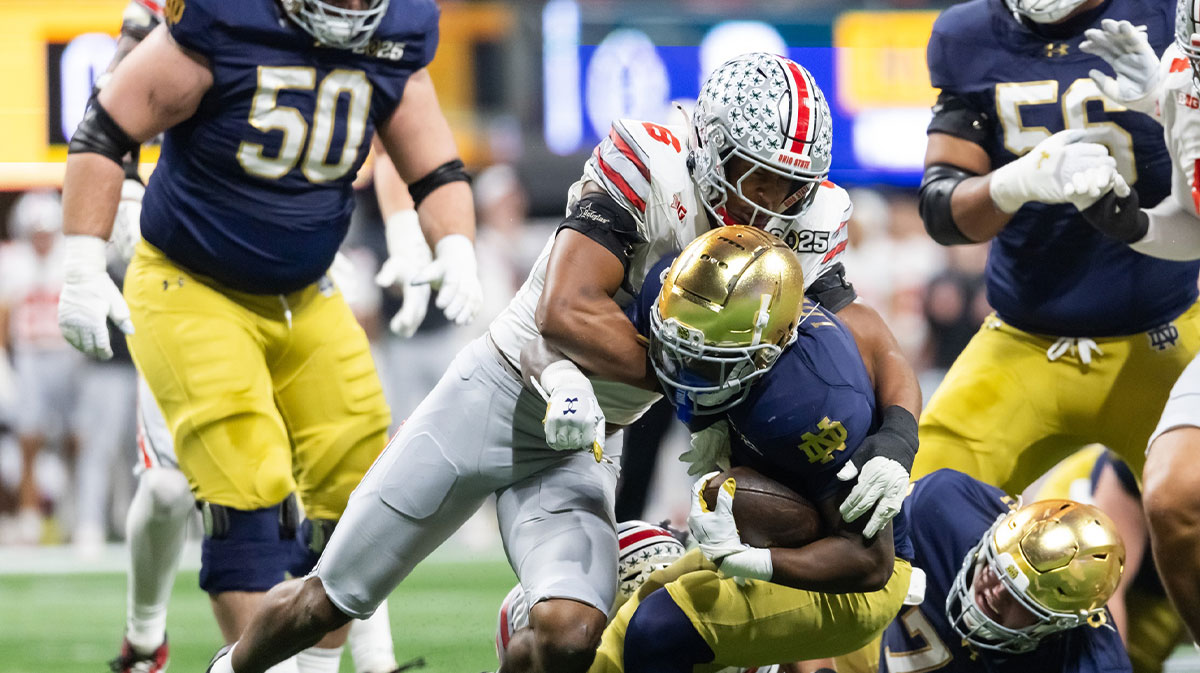 Ohio State Buckeyes linebacker Sonny Styles (6) tackles Notre Dame Fighting Irish running back Jeremiyah Love (4) during the CFP National Championship college football game at Mercedes-Benz Stadium.