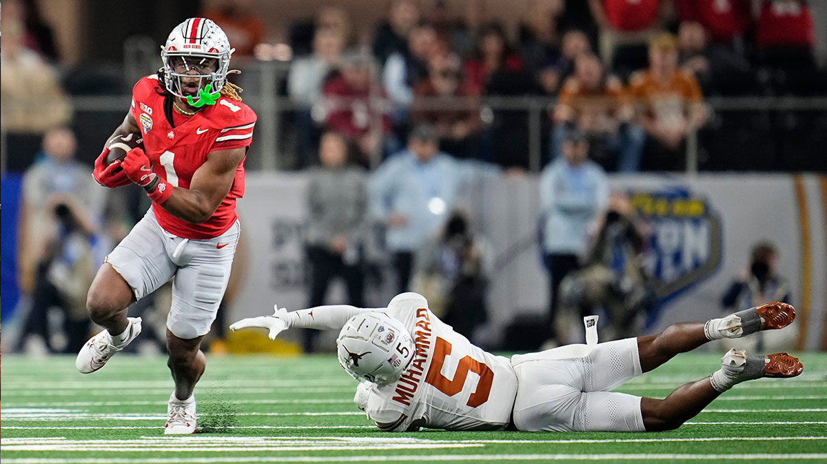 Ohio State Buckeyes running back Quinshon Judkins (1) runs around Texas Longhorns defensive back Malik Muhammad (5) during the second half of the Cotton Bowl Classic College Football Playoff semifinal game