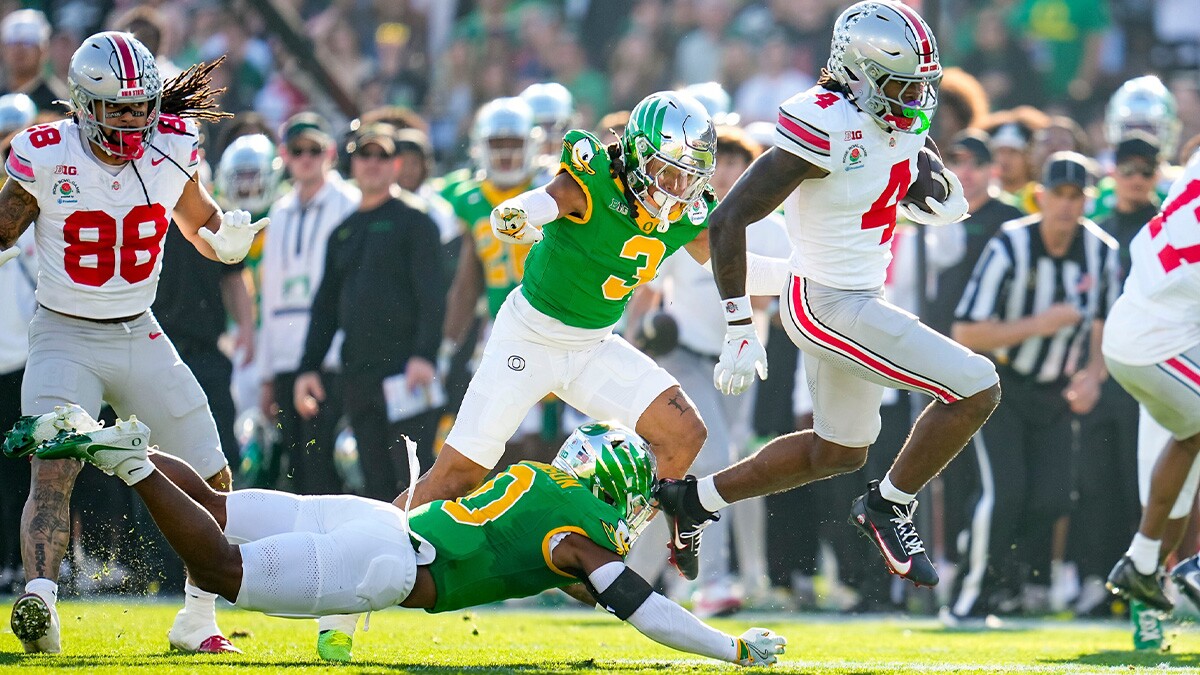 Ohio State Buckeyes wide receiver Jeremiah Smith (4) leaps past Oregon Ducks defensive back Tysheem Johnson (0) on his way to scoring a touchdown during the College Football Playoff quarterfinal at the Rose Bowl in Pasadena, Calif. on Jan. 1, 2025. Ohio State won 41-21. 