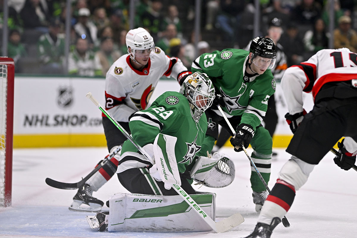 Ottawa Senators center Shane Pinto (12) and Dallas Stars defenseman Esa Lindell (23) and goaltender Jake Oettinger (29) look for the puck in the Stars zone during the third period at the American Airlines Center