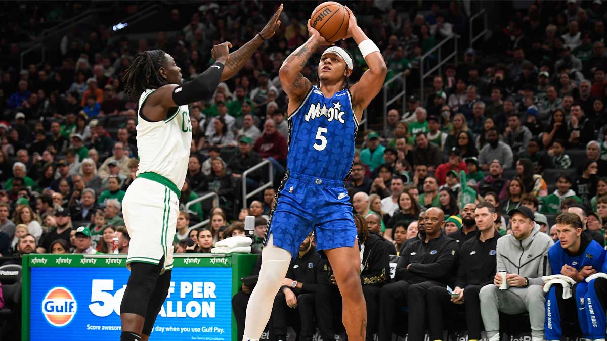 Orlando Magic forward Paolo Banchero (5) shoots the ball over Boston Celtics guard Jrue Holiday (4) during the first half at TD Garden.