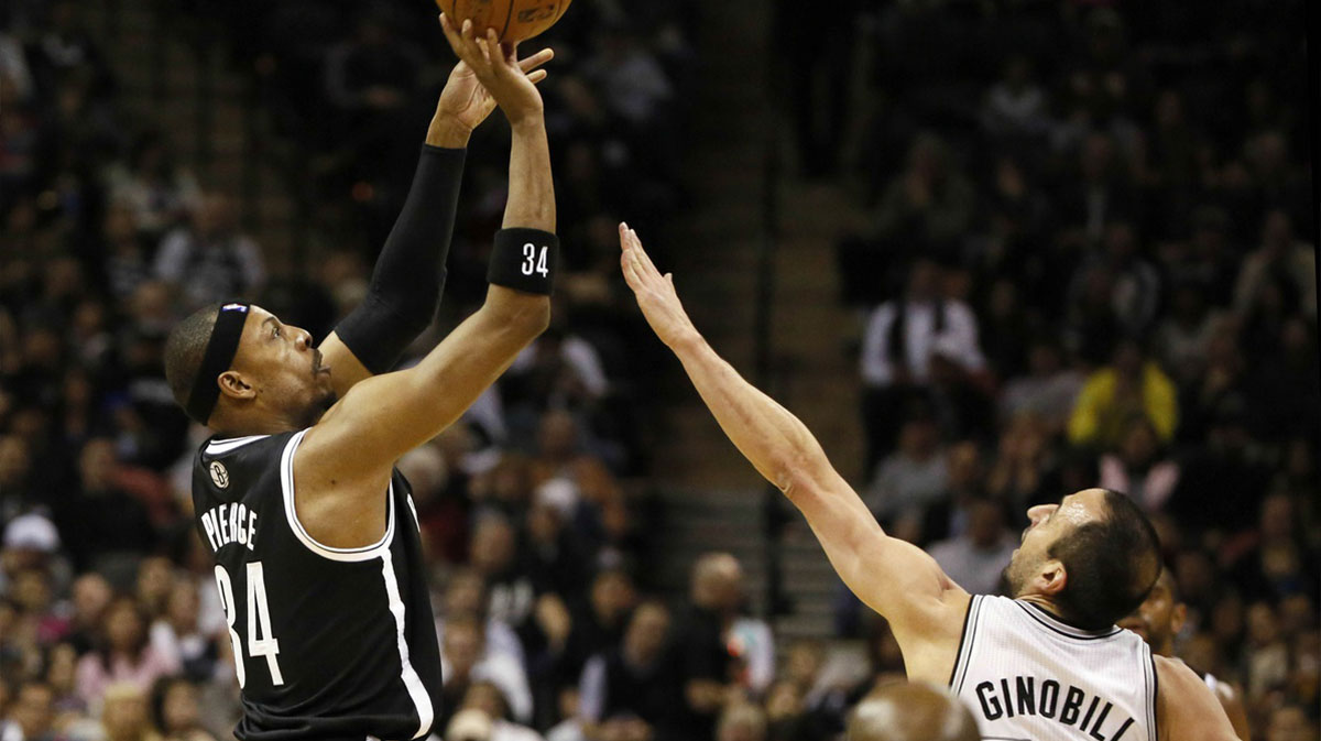 Brooklyn networks forward Paul Pierce (34) shooting while defending San Antonio Spurs Guard Manu Ginobili (20) during the first half at the AT & T Center AT & T.